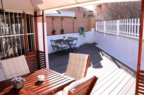 a patio with a table and chairs and an umbrella at Plaza de España independent house in Barcelona