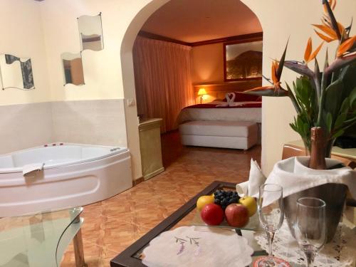 a bathroom with a tub and a table with fruit on it at VV APARTAMENTOS ESTRELLA DEL NORTE in Icod de los Vinos