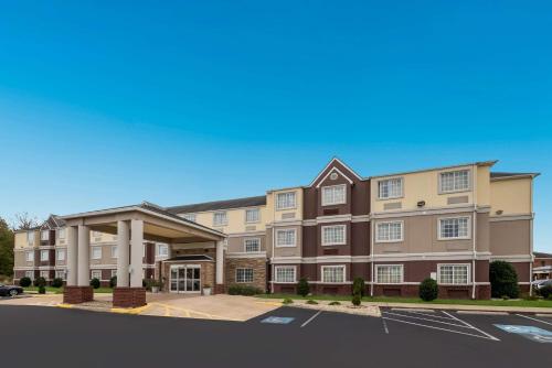an image of the front of a hotel with a parking lot at SureStay Plus Hotel by Best Western Elizabeth City in Elizabeth City