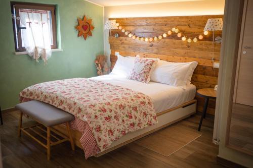 a bedroom with a large bed with a wooden headboard at Peperosa in collina B&B in Pescara