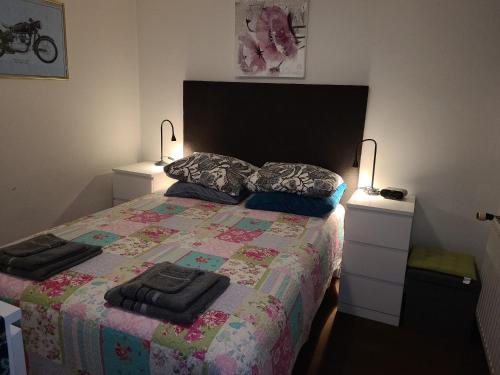 a bedroom with a bed with two night stands and two lamps at Ser's Studio Orange in Maastricht