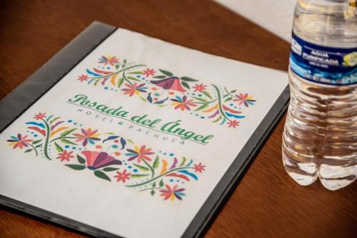 a bottle of water sitting on a table with a napkin at Posada del Ángel in Pachuca de Soto
