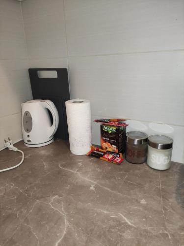 a kitchen counter with a coffee maker and some food at Nota Home in Novi Sad