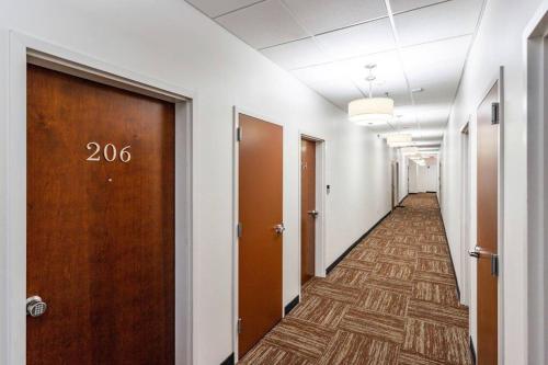 a corridor of an office building with a hallway with doors at Centric Modern Loft w/ King Beds & Smart GameTable in Rochester