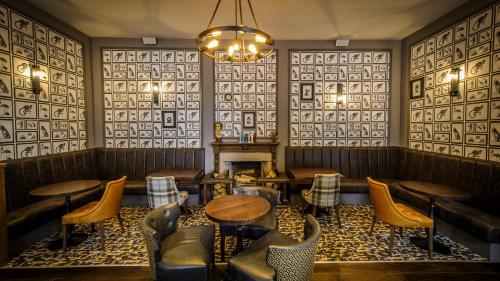 a restaurant with tables and chairs and a chandelier at Banchory Lodge Hotel in Banchory