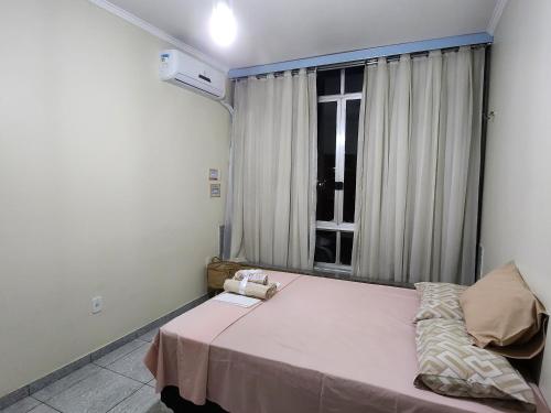 a bedroom with a large bed with a window at Apto com vista para Baía do Guajará in Belém