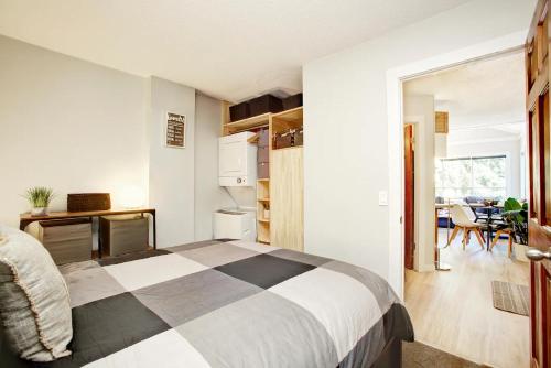 a bedroom with a bed and a dining room at Gondola Haus - Free parking in Whistler