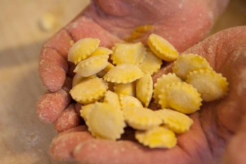 a hand holding a handful of yellow corn kernels at La Rondanina in Castelnuovo Fogliani