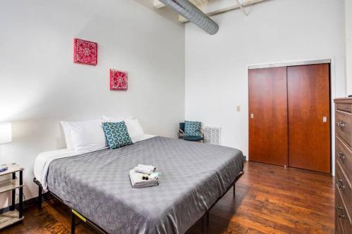 1 dormitorio con 1 cama grande y armario de madera en Centric NY Style Loft w/King bed, en Rochester
