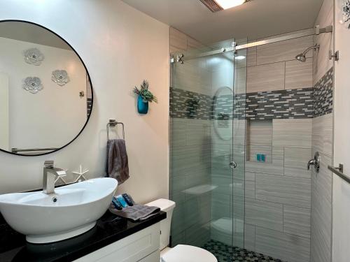 a bathroom with a sink and a glass shower at Hilltop Villa, Pool, Hot tub, Views, Avocado Grove in Fallbrook
