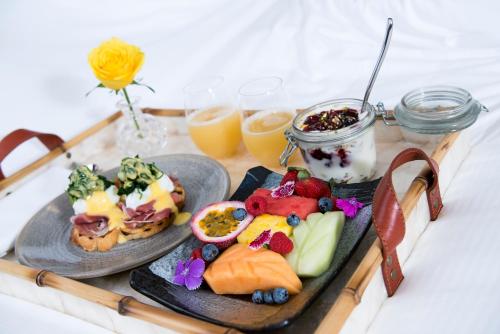 a tray with two plates of food on a table at Rydges South Bank Brisbane in Brisbane