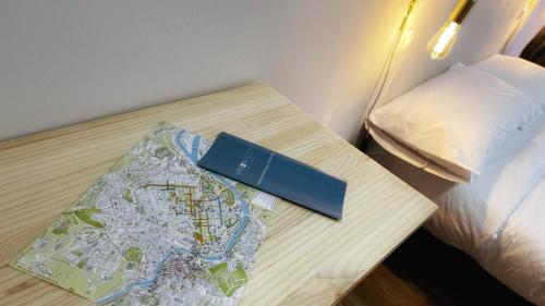 a table with a map and a book on it at Iturriaga Ostatua Self check in in Bilbao