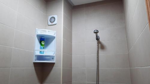 a shower with a soap dispenser in a bathroom at Salòs del Comfort in Oualidia