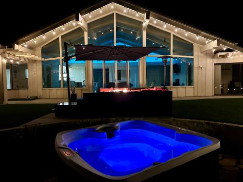a blue tub in front of a house at night at Hilltop Villa, Pool, Hot tub, Views, Avocado Grove in Fallbrook