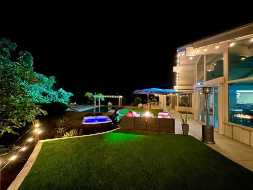 a backyard at night with a green lawn at Hilltop Villa, Pool, Hot tub, Views, Avocado Grove in Fallbrook