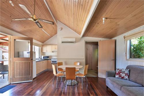 a kitchen and living room with a table and chairs at NRMA Bathurst Panorama Holiday Park in Bathurst