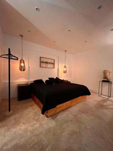 a bedroom with a bed and a cross in it at Hotel Atia in Guadalajara