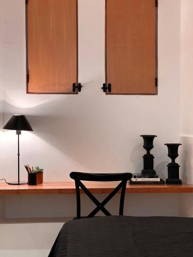 a bedroom with a desk with a chair and cabinets at Hotel Atia in Guadalajara