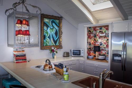 a kitchen with a sink and a refrigerator at Rio Sierra Riverhouse in Three Rivers