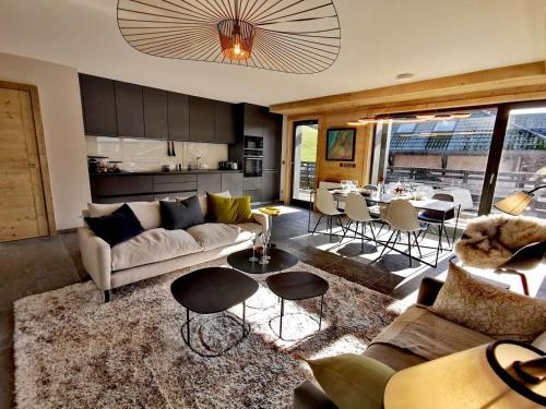 un salon avec un canapé et une table dans l'établissement Appartement standing 100m², pied des pistes, 8 pers, terrasse, WiFi, parking - FR-1-598-43, aux Gets