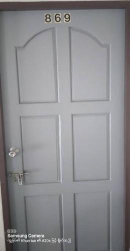 a white door with a number on it at Rooftop room in We Residence in Pattaya