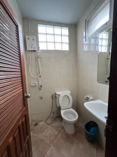 a bathroom with a toilet and a sink at Rooftop room in We Residence in Pattaya