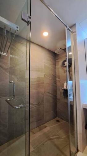 a shower with a glass door in a bathroom at Apartment Pelita Batam Floor 21 no 5 Studio with Balcony in Nagoya