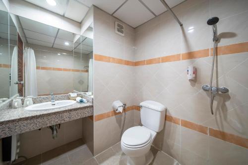 a bathroom with a toilet and a sink at Bella Villa Pattaya 3rd Road in Pattaya