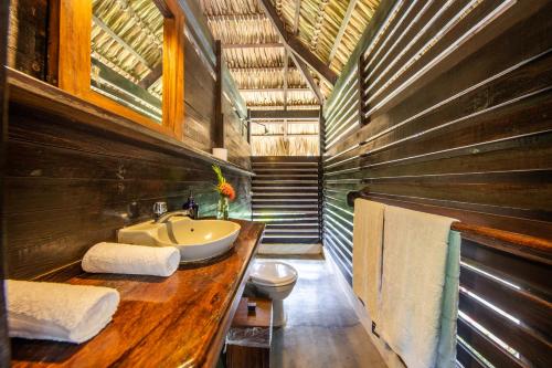 a bathroom with a sink and a toilet at Buena Vista Surf Club in Playa Maderas