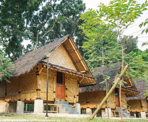 a small building with a straw roof at INAGRO in Bogor