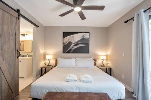 a bedroom with a large bed with two towels on it at Heart of Old Town Scottsdale in Scottsdale