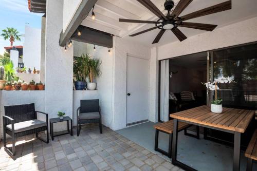 a patio with a table and chairs and a ceiling fan at Heart of Old Town Scottsdale in Scottsdale