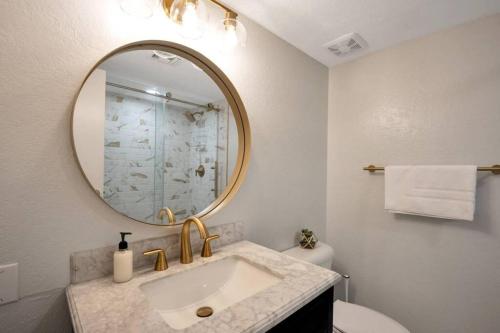 a bathroom with a sink and a mirror at Heart of Old Town Scottsdale in Scottsdale