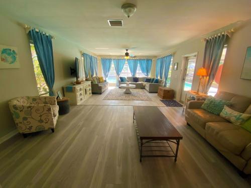 a living room with a couch and a table at Blue Heron House, Private 4 BR Waterfront w Heated Pool and Fire Pit in Ruskin