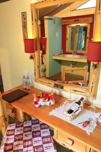 a bathroom vanity with a mirror and a sink at Manyatta Camp in Voi