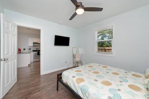 a bedroom with a bed and a ceiling fan at Stylish 2 bedroom home close 2 dtown, nas, and bch in Pensacola