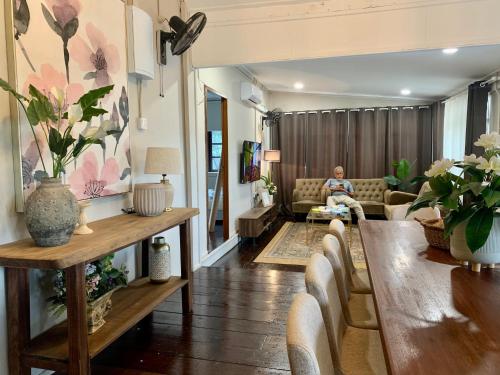 a man sitting on a couch in a living room at VillaKampung in Kuala Terengganu