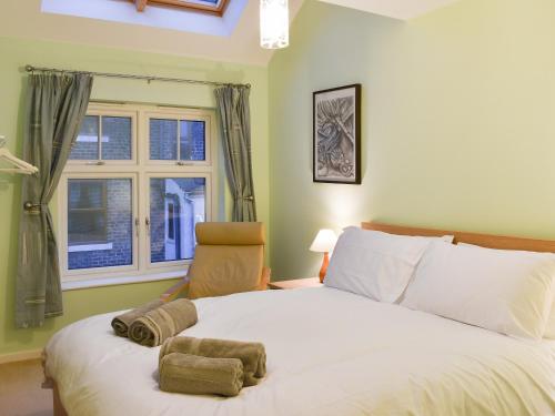 Un pat sau paturi într-o cameră la The Retreat
