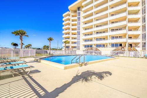 a swimming pool in front of a large apartment building at Perdido Sun Resort 1108 by PKRM in Pensacola
