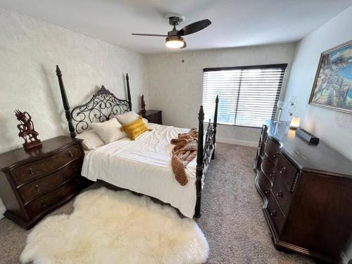a bedroom with a bed and a dresser and a window at Cozy Private Condo near Hall of Fame in Hollywood in Los Angeles