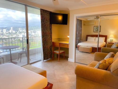 um quarto de hotel com uma cama e uma varanda em Charming Royal Garden condo em Honolulu