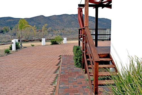 a set of wooden stairs leading up to a house at Vides del Rio Suites in Valle de Guadalupe