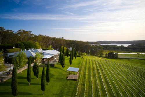 an aerial view of a farm with a field and a building at Cupitt's Estate Villas in Ulladulla