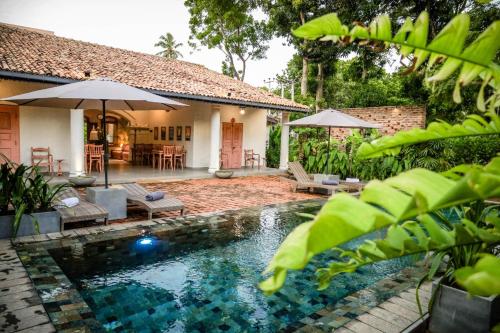 a swimming pool in the backyard of a house at Villa Don Bastian in Tangalle