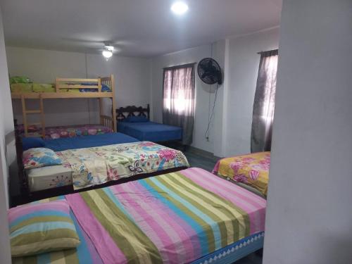 a bedroom with two beds and a bunk bed at Habitaciones Grupales in Playas