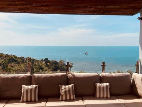 a couch in a room with a view of the ocean at St Barth Villas in Salad Beach