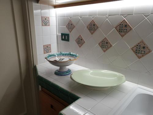 a bathroom with a sink and a bowl on a counter at APPARTAMENTO 21 in San Vito lo Capo