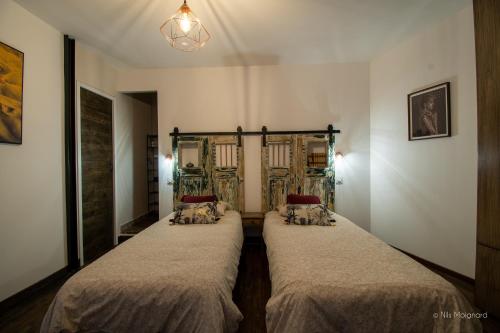 a room with two beds in a room at Appartement Grenat Bourg d'Oisans in Le Bourg-dʼOisans