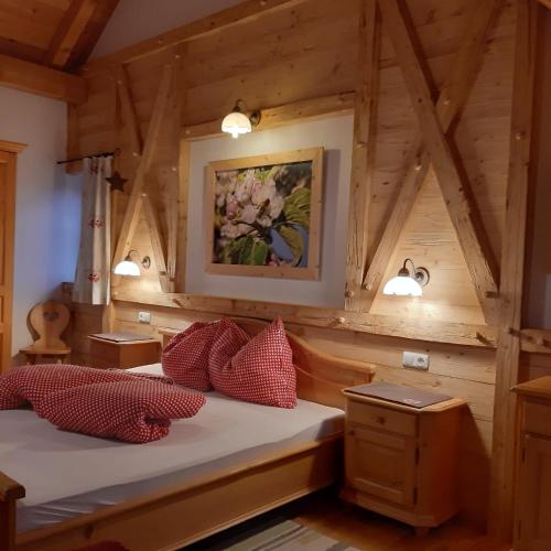 a bedroom in a log cabin with two beds at Ferienhof Margarethengut in Unterach am Attersee