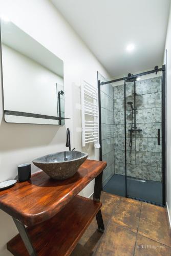 a bathroom with a sink and a glass shower at Appartement Grenat Bourg d'Oisans in Le Bourg-dʼOisans